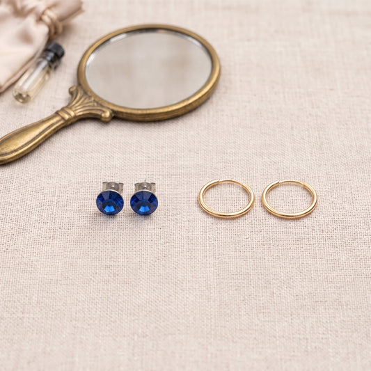 Comparing a pair of crystal stud earrings with a pair of thin gold hoops