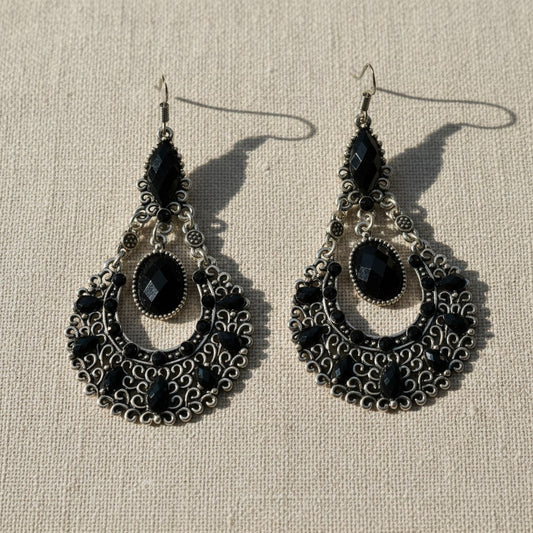 Amare Tutto bohemian chandelier earrings in antiqued silver with black faceted stones and intricate filigree detail.